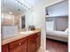 Bathroom featuring vanity with wood cabinets, and a shower with glass door at 4826 San Ortebello Dr, Bradenton, FL 34208