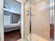Bathroom view showcasing shower stall, wood-look flooring, and bedroom access at 4826 San Ortebello Dr, Bradenton, FL 34208