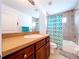 Bathroom showcasing a vanity with wooden cabinets and a tub-shower combination at 4826 San Ortebello Dr, Bradenton, FL 34208