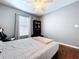 Bedroom featuring a comfortable bed, ceiling fan, curtains, and a bookshelf at 4826 San Ortebello Dr, Bradenton, FL 34208