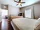 This bedroom features hardwood floors, a ceiling fan and a large window at 4826 San Ortebello Dr, Bradenton, FL 34208