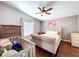 This bedroom features hardwood floors, a ceiling fan, and neutral wall color at 4826 San Ortebello Dr, Bradenton, FL 34208