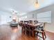 Dining room features modern lighting fixture, hardwood flooring, and views of the living room at 4826 San Ortebello Dr, Bradenton, FL 34208