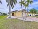 Inviting home with well-manicured lawn, brick-paver walkway, and charming entrance at 4826 San Ortebello Dr, Bradenton, FL 34208
