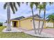 Single Gathering home featuring an attached two-car garage, landscaping with decorative stones and palm trees at 4826 San Ortebello Dr, Bradenton, FL 34208