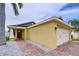 Home featuring an attached two-car garage, side entry door, and decorative stone landscaping at 4826 San Ortebello Dr, Bradenton, FL 34208