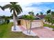 Well-maintained home featuring a paved driveway, palm trees, and meticulous landscaping at 4826 San Ortebello Dr, Bradenton, FL 34208