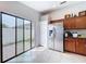 Bright kitchen featuring stainless refrigerator and sliding door access to outdoor patio at 4826 San Ortebello Dr, Bradenton, FL 34208