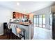Kitchen featuring stainless steel appliances, a breakfast bar, and sliding glass doors to the outside at 4826 San Ortebello Dr, Bradenton, FL 34208