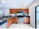 Well-equipped kitchen featuring wood cabinets, a modern range, and tile flooring at 4826 San Ortebello Dr, Bradenton, FL 34208