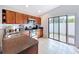 This kitchen features wooden cabinets, stainless steel appliances, and sliding door access at 4826 San Ortebello Dr, Bradenton, FL 34208