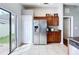 Kitchen featuring stainless refrigerator and sliding door access to outdoor patio at 4826 San Ortebello Dr, Bradenton, FL 34208