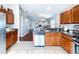 Spacious kitchen with stainless steel appliances and wood cabinets, open to the living area at 4826 San Ortebello Dr, Bradenton, FL 34208