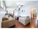 Bright living area with hardwood floors, fan, modern furnishings, and open layout to the dining area at 4826 San Ortebello Dr, Bradenton, FL 34208