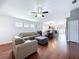 Open living area with hardwood floors, modern ceiling fan, and comfortable gray leather furniture set at 4826 San Ortebello Dr, Bradenton, FL 34208