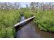 Scenic aerial view of a wooden walkway through mangroves and water at 4826 San Ortebello Dr, Bradenton, FL 34208