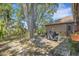 Beautiful backyard with mature trees, barbecue grill, and a stone patio area at 4926 72Nd E St, Bradenton, FL 34203