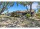 Charming backyard with beautiful landscaping, birdhouse, and plenty of shade from mature trees at 4926 72Nd E St, Bradenton, FL 34203