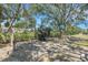 Serene backyard with mature trees, garden decorations, and plenty of space at 4926 72Nd E St, Bradenton, FL 34203