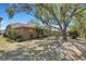 Well-maintained backyard with mature trees, landscaped garden beds, and a private setting at 4926 72Nd E St, Bradenton, FL 34203