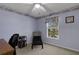 Comfortable bedroom, designed as a home office, with blue walls and carpeted floors at 4926 72Nd E St, Bradenton, FL 34203