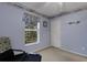 Cozy bedroom with soothing blue walls, closet, and window overlooking the lush backyard at 4926 72Nd E St, Bradenton, FL 34203