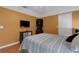 Comfortable bedroom featuring warm yellow walls and wood laminate flooring at 4926 72Nd E St, Bradenton, FL 34203