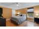Comfortable bedroom featuring warm yellow walls and wood laminate flooring at 4926 72Nd E St, Bradenton, FL 34203