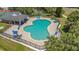 A large community pool surrounded by lounge chairs and lush landscaping at 4926 72Nd E St, Bradenton, FL 34203