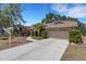 Well-manicured landscaping frames the driveway of this single-story home at 4926 72Nd E St, Bradenton, FL 34203