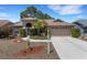 Inviting home featuring a well-maintained lawn, mature landscaping, and a two-car garage at 4926 72Nd E St, Bradenton, FL 34203