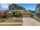 Charming single-story home with a well-manicured lawn, palm trees, and a two-car garage at 4926 72Nd E St, Bradenton, FL 34203
