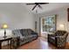 Comfortable living room with hardwood floors, a ceiling fan, and a large window overlooking the outdoors at 4926 72Nd E St, Bradenton, FL 34203