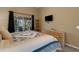 Serene main bedroom with sliding glass door to lanai and tv at 4926 72Nd E St, Bradenton, FL 34203