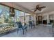Relaxing screened-in patio with ceiling fan and lush plants, perfect for entertaining at 4926 72Nd E St, Bradenton, FL 34203