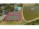 Aerial view of tennis courts, a pool, and a pond with a fountain in the Creekwood Lakeside community at 4926 72Nd E St, Bradenton, FL 34203