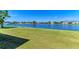 Scenic view of the lake with a well-maintained lawn offering a peaceful ambiance at 5102 98Th E Ave, Parrish, FL 34219
