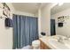Neutral bathroom featuring vanity and a shower with blue curtain at 5102 98Th E Ave, Parrish, FL 34219
