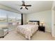 Bright bedroom with water view, ceiling fan, carpet and neutral walls at 5102 98Th E Ave, Parrish, FL 34219