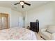 Bedroom featuring neutral walls and flooring, ceiling fan, an ensuite bathroom, and a large window at 5102 98Th E Ave, Parrish, FL 34219