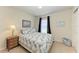 Well-lit bedroom with carpeted floor, neutral walls, ceiling fan, and a side table at 5102 98Th E Ave, Parrish, FL 34219