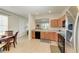 Bright eat-in kitchen with stainless steel appliances and wood cabinets; view to living area and water at 5102 98Th E Ave, Parrish, FL 34219