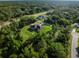 Scenic aerial view of the property highlighting its generous lot size and proximity to lush greenery and roadways at 5955 Ferendina St, North Port, FL 34291