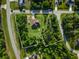 Sprawling property featuring mature trees surrounding the residence at 5955 Ferendina St, North Port, FL 34291