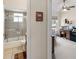 View of bathroom with tiled shower and toilet and bedroom featuring desk and chair at 5955 Ferendina St, North Port, FL 34291