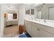 Bright bathroom features double sinks, vanity, and access to a serene bedroom at 5955 Ferendina St, North Port, FL 34291