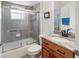 Bathroom with tub, shower, glass door and modern vanity with marble countertop at 5955 Ferendina St, North Port, FL 34291