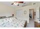 This bedroom features floral bedding, double closet, and leads to the Primary bathroom at 5955 Ferendina St, North Port, FL 34291