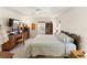 This primary bedroom has neutral walls, a ceiling fan, and large windows overlooking the yard at 5955 Ferendina St, North Port, FL 34291