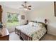 This bedroom features a large window with a view of the backyard at 5955 Ferendina St, North Port, FL 34291